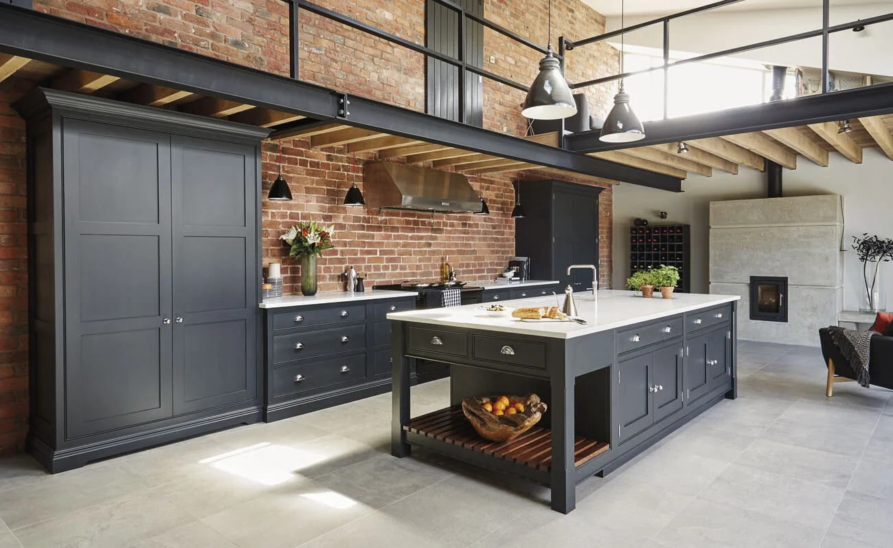 Modern kitchen with brick walls and central island design.